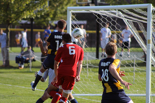 Players watch the pall during a shot on goal during Friday's game. 