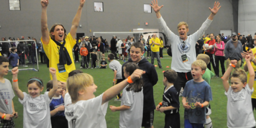 Stevenson Hawkey, Alexi Lalas and children play a game of soccer at Soccer Night in Newtown on Jan. 7.