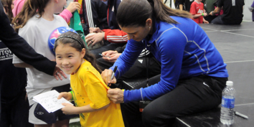 Mia Hamm signs a girl's shirt at Monday's Soccer Night in Newtown.