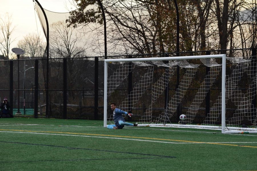 Junior goalkeeper Jared Mazzola watches as a penalty shot sails into the net.