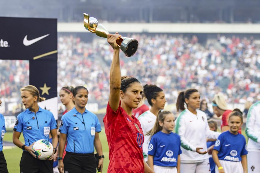 United States Women’s National Team forward Carli Lloyd hoists the 2019 Women’s World Cup trophy.