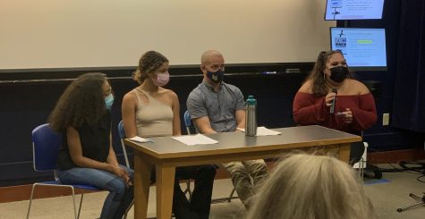 Three students read pieces regarding their cultures and identities alongside Quinnipiac professor J.T. Torres.