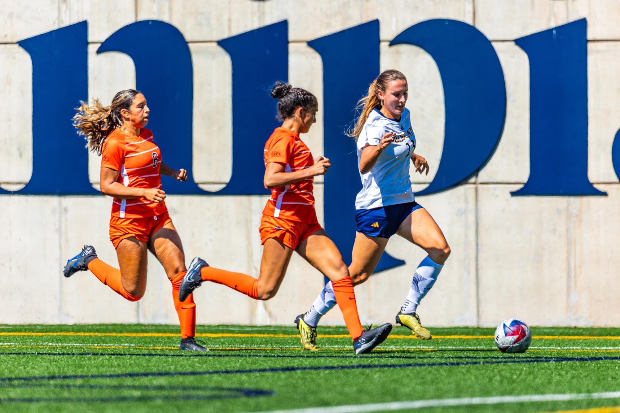 Senior forward Courtney Chochol, right, dribbles the ball away from defenders on Sunday, September 17, 2023 at the Quinnipiac Univeristy Soccer & Lacrosse Stadium.