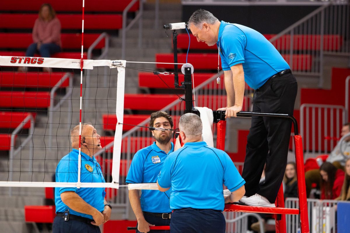 Officials come together to discuss a call made in Quinnipiac volleyball's semifinal match against Iona on Nov. 18. 