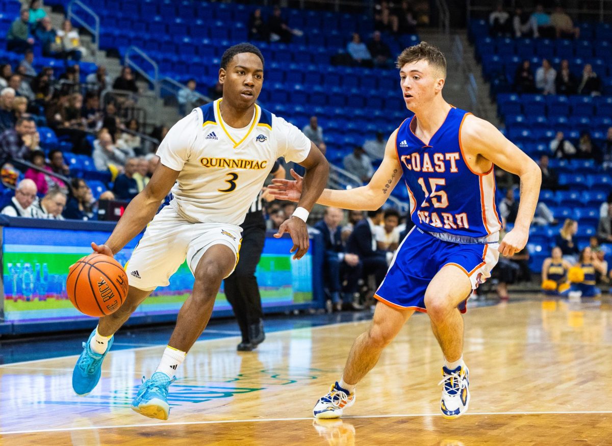 Graduate student guard Savion Lewis drives to the net against Coast Guard on Nov. 6, 2023.