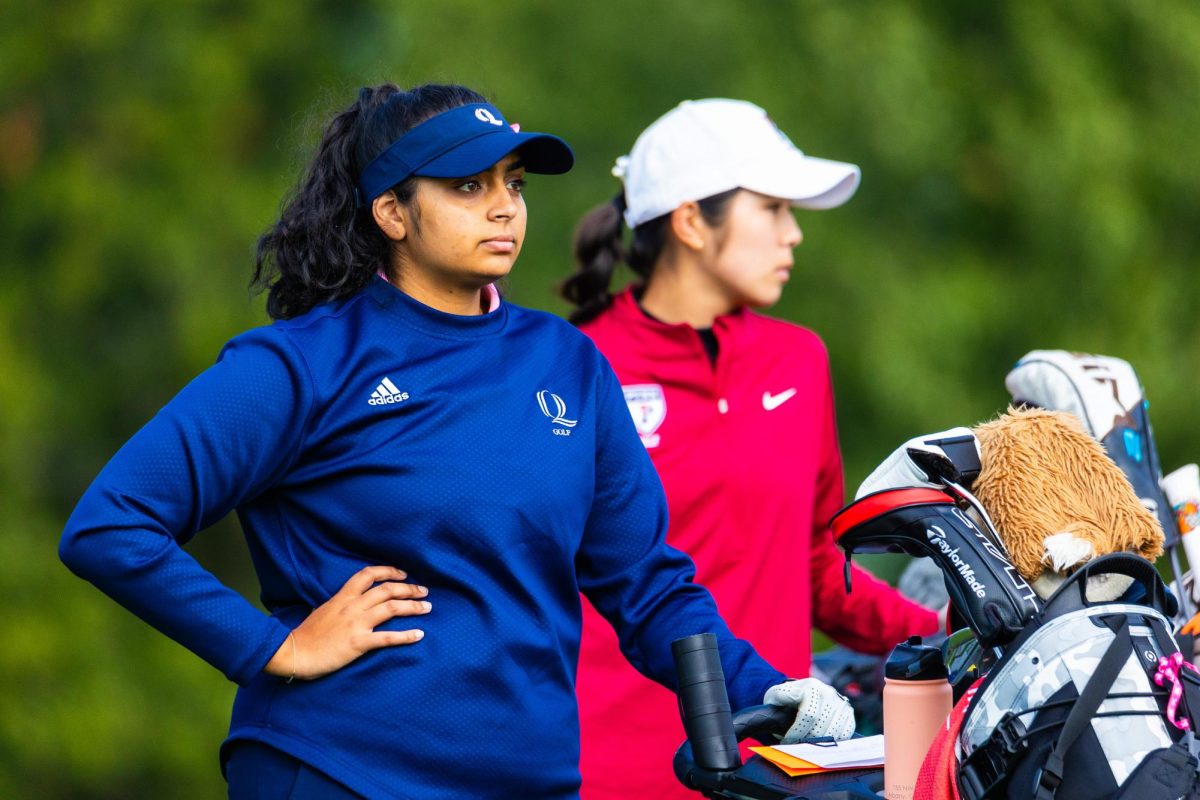 Sophomore Sandhya Vaikuntam stands with her bag at The Farms Country Club in Wallingford, CT during the Quinnipiac Classic on Monday, October 9, 2023.