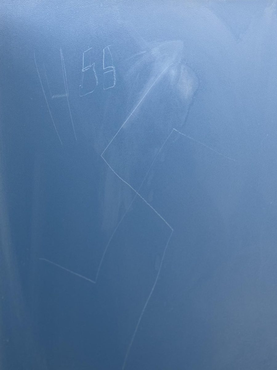 A swastika and other anti-Jewish hate symbols carved into a bathroom stall in M&T Bank Arena on Feb. 27. Vandalism accounted for 40% of campus crimes in February.