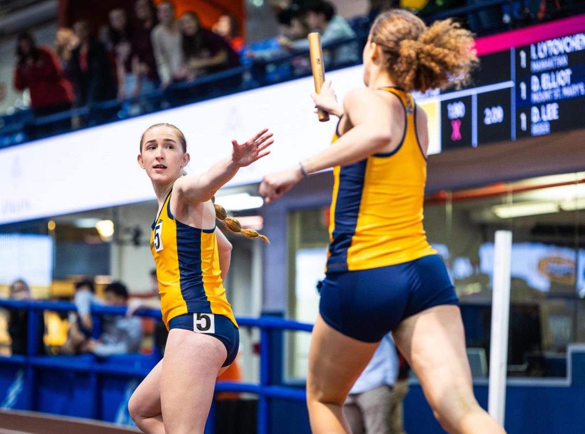 Sophomore Elise Barricelli (right) hands a baton to senior Asia Mercier during the women's distance medley relay on day one of the MAAC Championships at The Armory in New York on Feb. 24