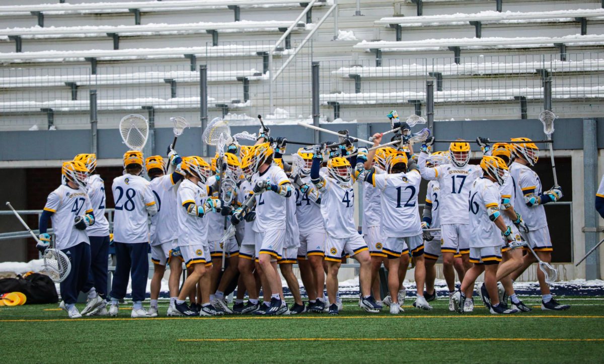 Quinnipiac men’s lacrosse celebrates a 13-7 win over Brown on Feb. 17.