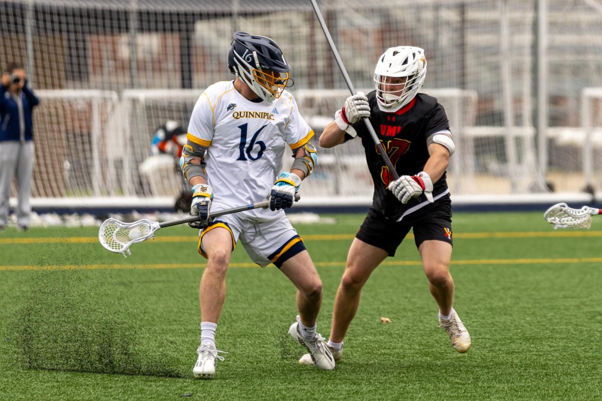 Graduate student attacker Jake Tellers fends off a defender in a game against VMI on April 13. 