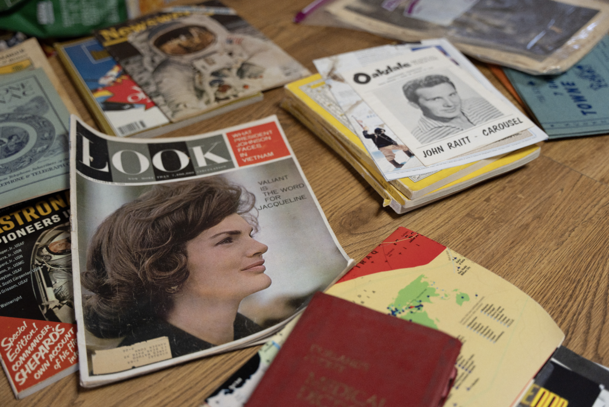 Historic books and magazine issues line the kitchen table of Gil and Helen Spencer on April 17.