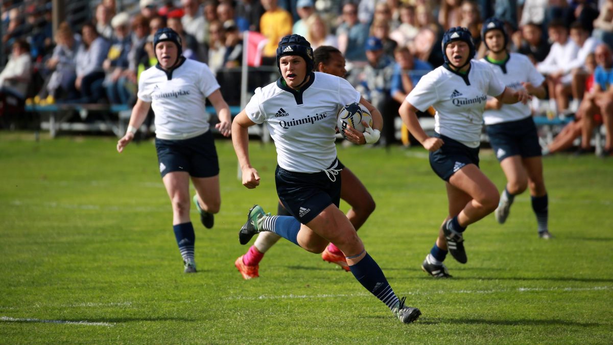 Former Quinnipiac rugby center Ilona Maher runs with the ball during a match.