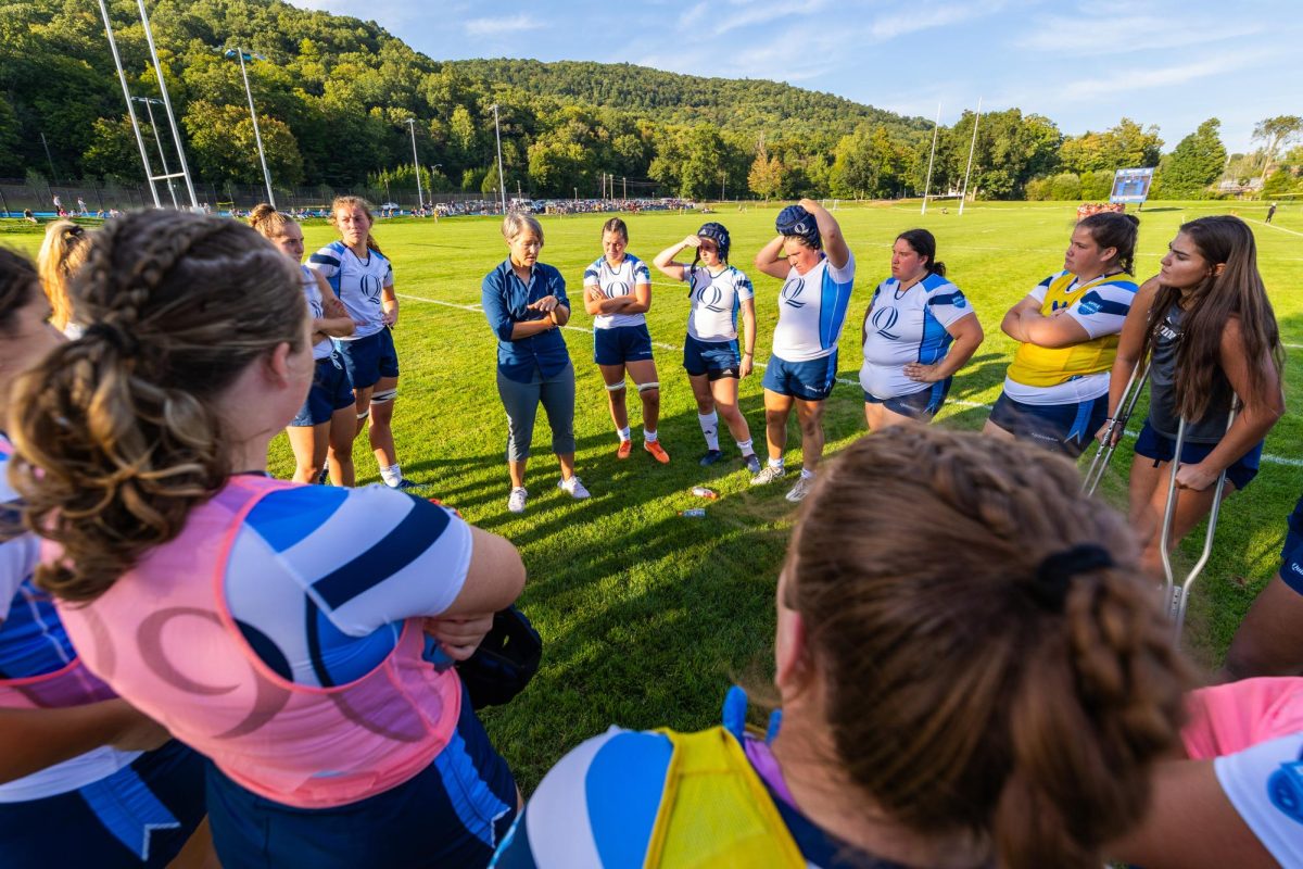 Women's rugby huddles during a game against Harvard on September 2, 2023.