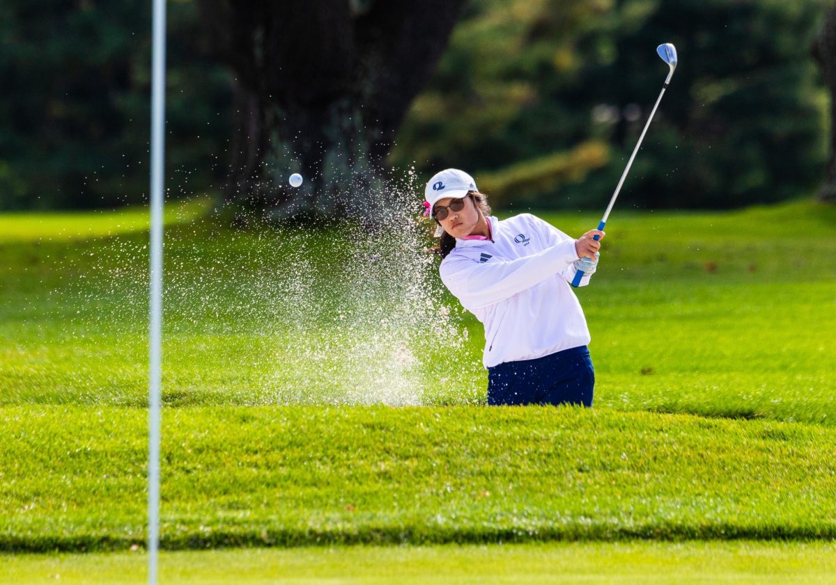 Senior Meg Yoshida hits out of the bunker at The Farms Country Club in Wallingford, CT during the Quinnipiac Classic on October 9, 2023.