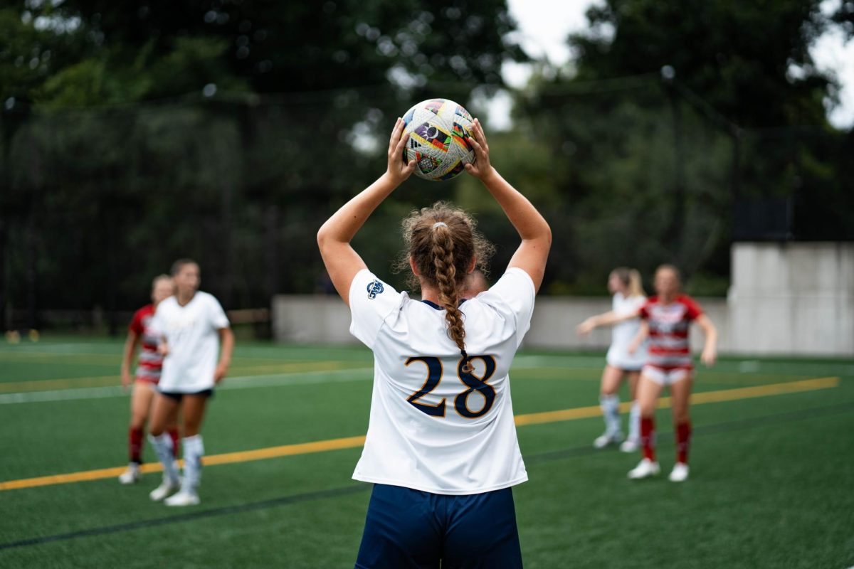 Sophomore midfielder Anna Bean prepares to throw the ball in against Sacred Heart on Sept. 7. 