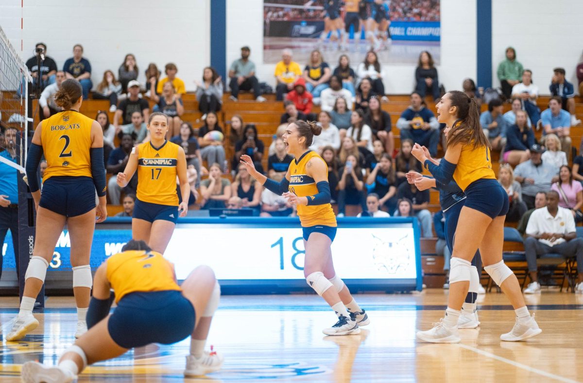 Quinnipiac volleyball celebrates a point in a four-set win against Sacred Heart on Oct. 6.