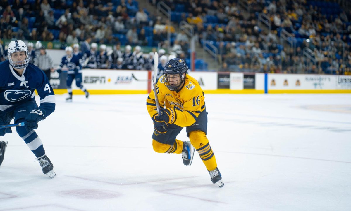 Junior forward Jeremy Wilmer skates toward the puck in a game against Penn State on Oct. 12.