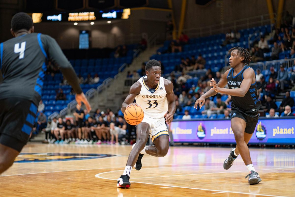 Graduate student forward Paul Otieno dribbles the ball against Albertus Magnus on Oct. 30.