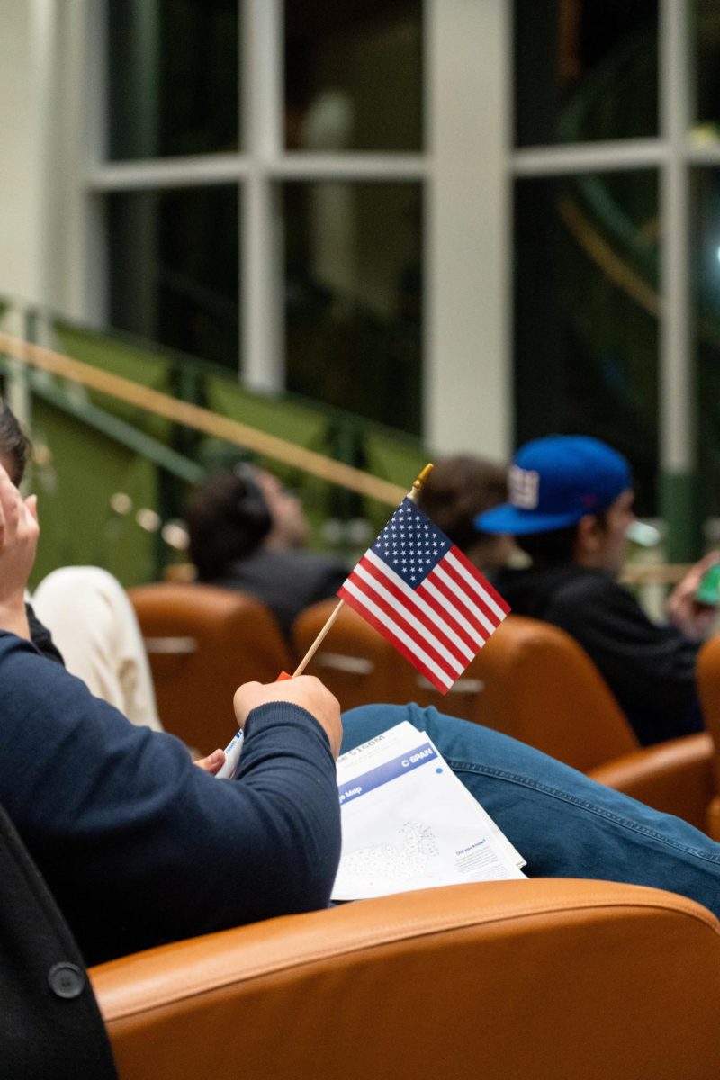 Students who attended the election watch party receive items like American flags