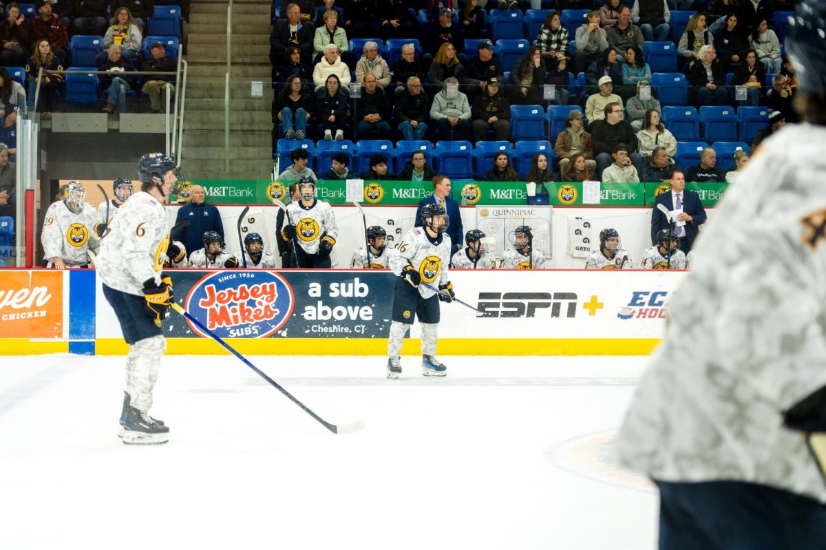 Juniors defenseman Charlie Leddy (left) and forward Jeremy Wilmer (middle) prepare for play against Harvard on Nov. 9.