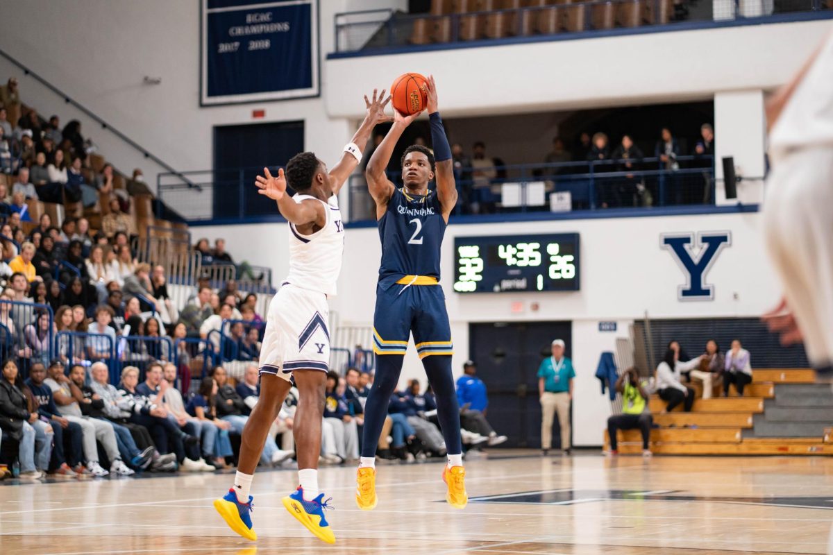 Junior forward Amarri Monroe shoots from beyond the arc in a 88-62 loss against Yale on Nov. 4. 