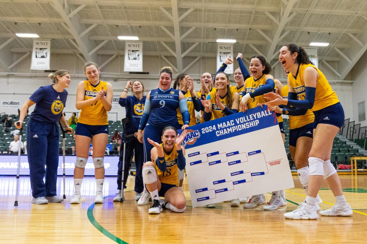 Quinnipiac volleyball celebrates after its 3-1 MAAC Semi-final win over Rider on Nov. 23, 2024.