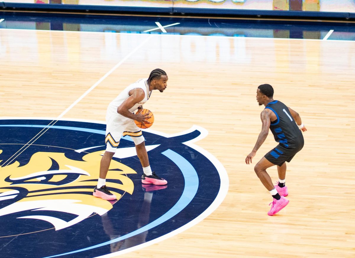 Senior guard Doug Young examines the defense in a 79-68 win against Albertus Magnus on Oct. 30. 