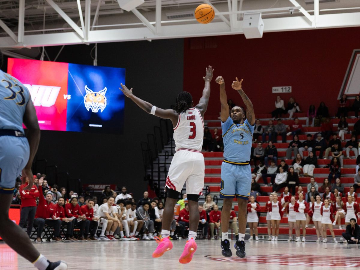 Senior guard Doug Young shoots a three-pointer in a 99-90 victory against Sacred Heart on Feb. 14.