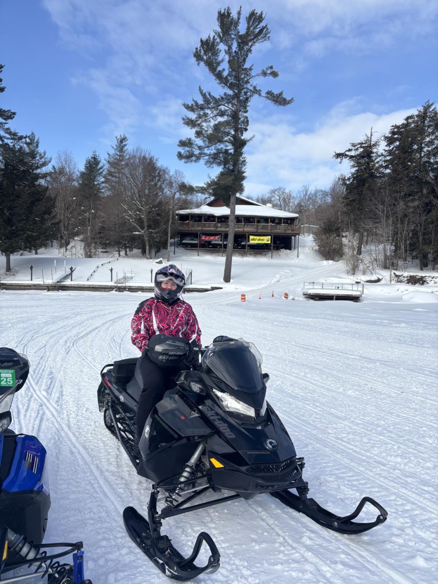 Arts & Life Editor Gina Lorusso on her snowmobile on Fourth Lake behind Daikers restaurant.