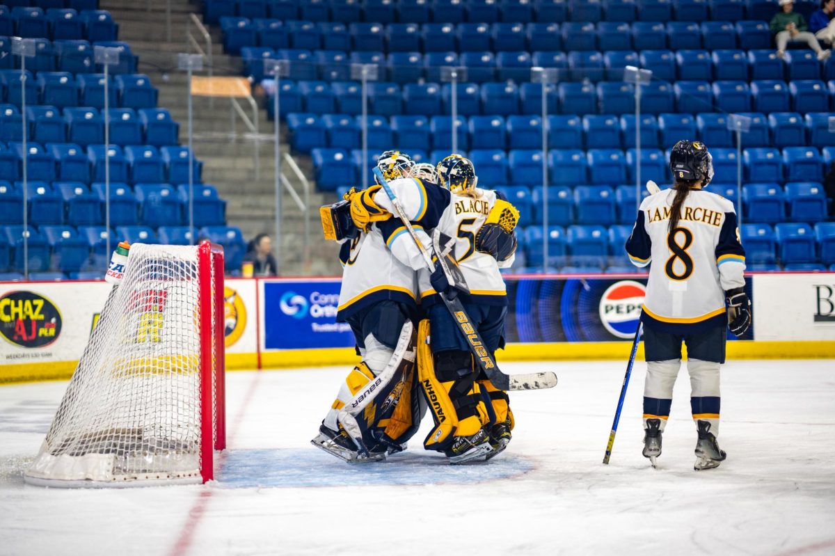 Quinnipiac women's ice hockey goalies celebrate after a 2-1 victory against Harvard on Jan. 31.