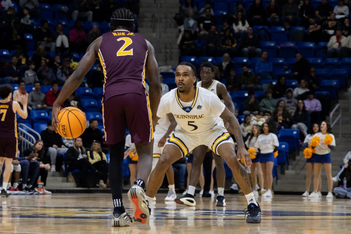 Senior guard Doug Young defends his opponent in a 79-74 victory against Iona on Feb. 16.