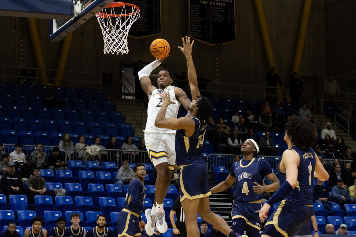 Junior forward Amarri Monroe attempts a dunk against Mount St. Mary's on March 6.