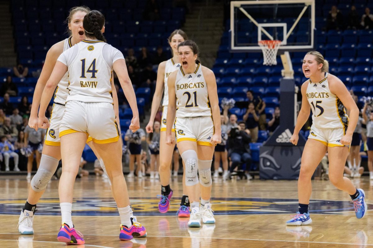 Freshman guard Gal Raviv celebrates with teammates in a 72-65 victory against Fairfield on March 8.