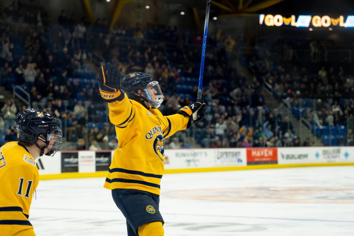 Graduate student forward Travis Treloar celebrates against Brown on Feb. 22.