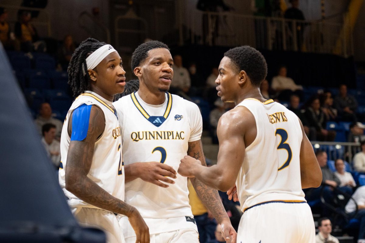 Freshman guard Jaden Zimmerman (left), junior forward Amarri Monroe (middle) and graduate student guard Savion Lewis (right) huddle during a 81-69 win against Fairfield on Jan. 31.