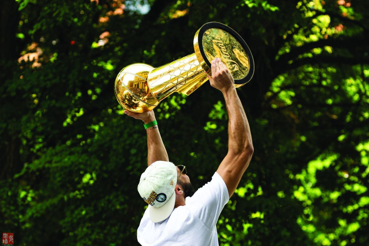 Jayson Tatum holds up the Boston Celtics’ 18th Larry O’Brien Championship Trophy during their victory parade on June 21, 2024.