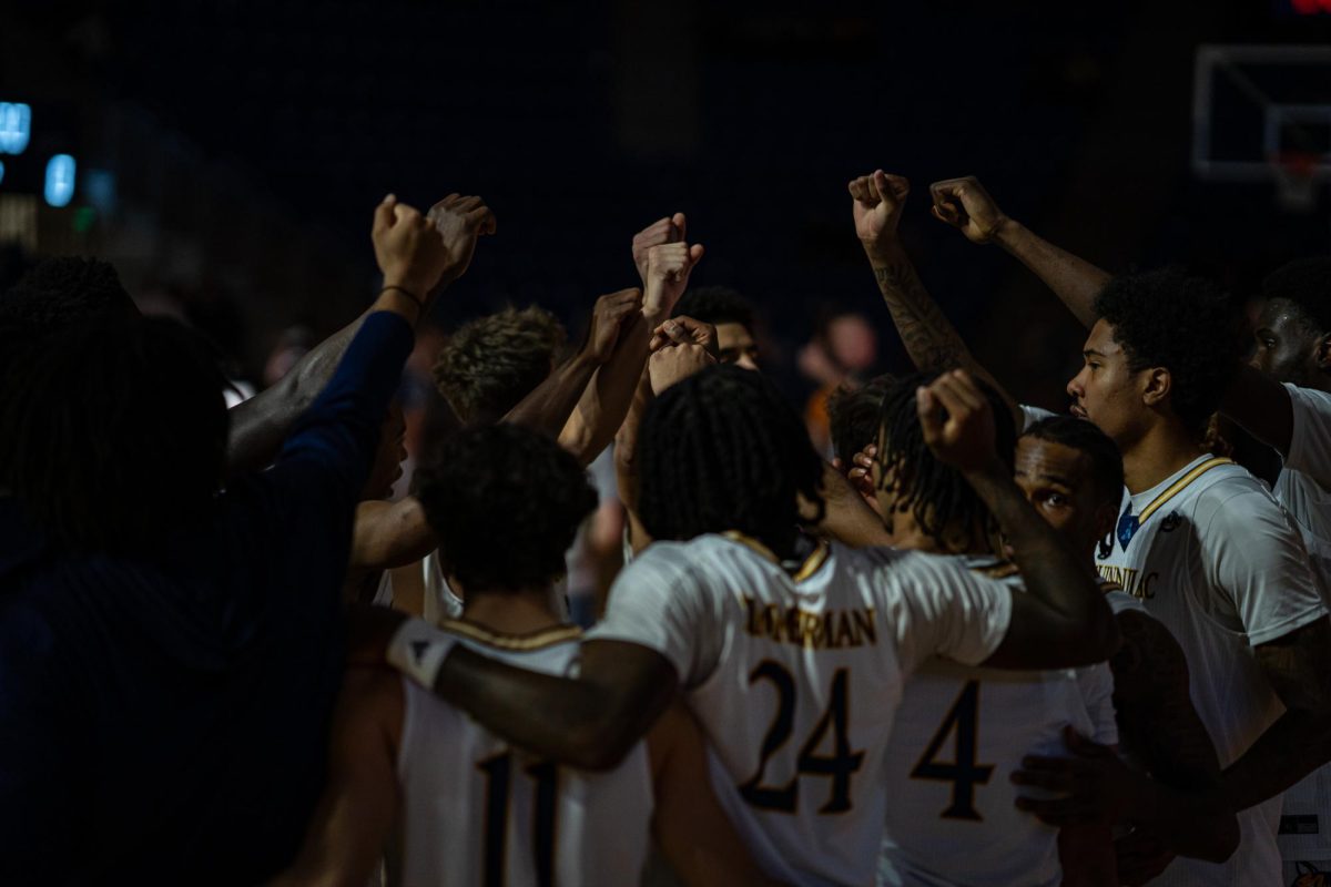 Quinnipiac men's basketball huddling together before facing off against WPI on Nov. 7. 