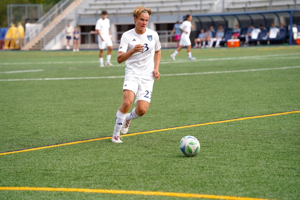 First-year defense Sixten Karlsson dribbles down the field against Long Island University on Sept. 16.