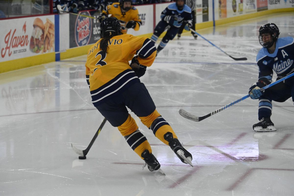 Sophomore defensemen Aynsley D'Ottavio skates down ice against Maine on Sept. 26.