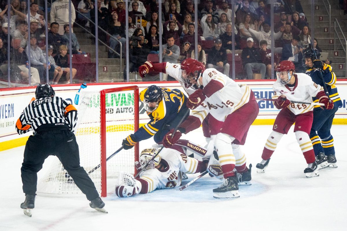 Sophomore forward Chris Pelosi buries the puck past the goal line behind the back of Eagle junior goaltender Jan Korec against Boston College on Oct. 3.