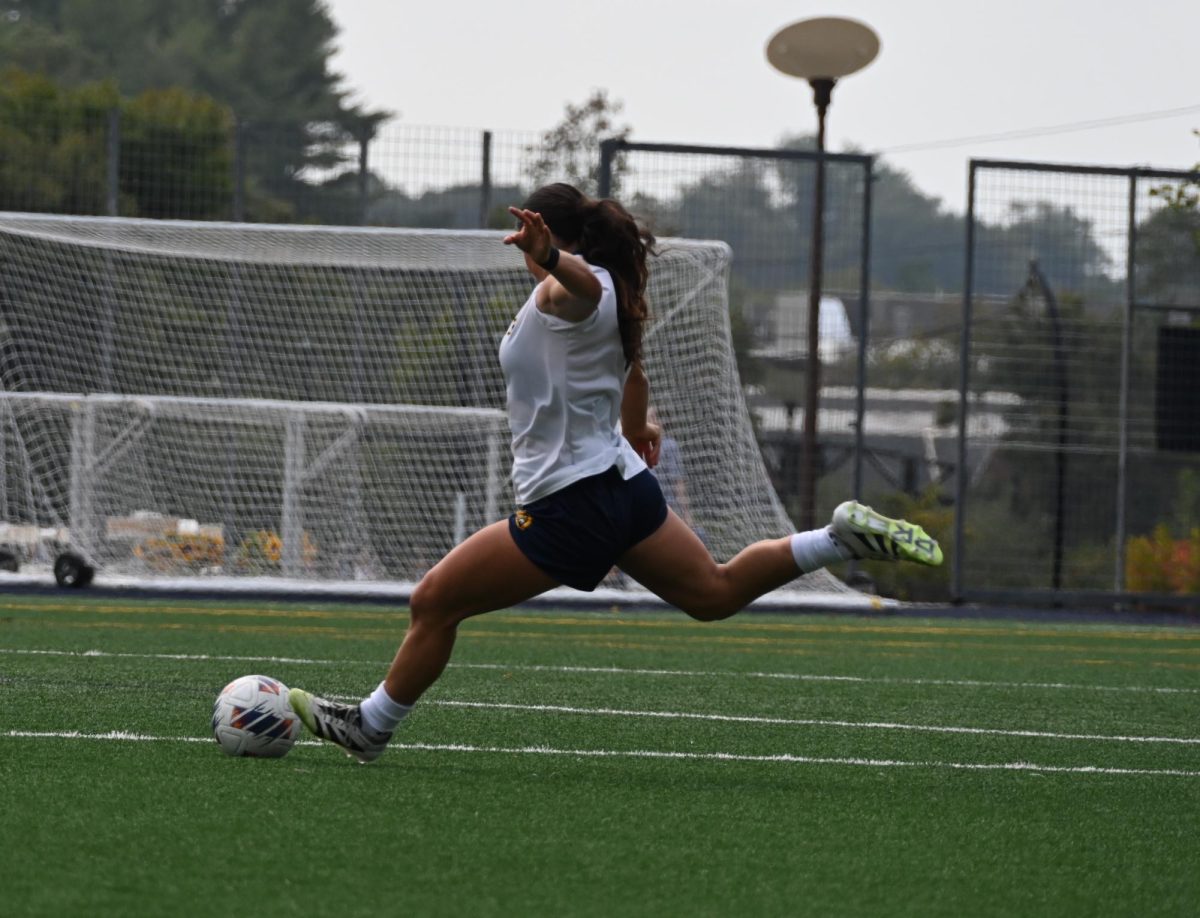 Senior defenseman Madison Alves kicks down the field against Rider on Sept. 6.