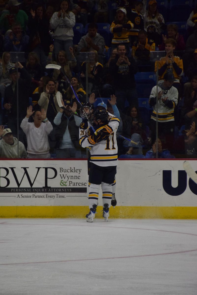 Quinnipiac men's ice hockey celebrates after scoring against UMaine on Oct. 18.
