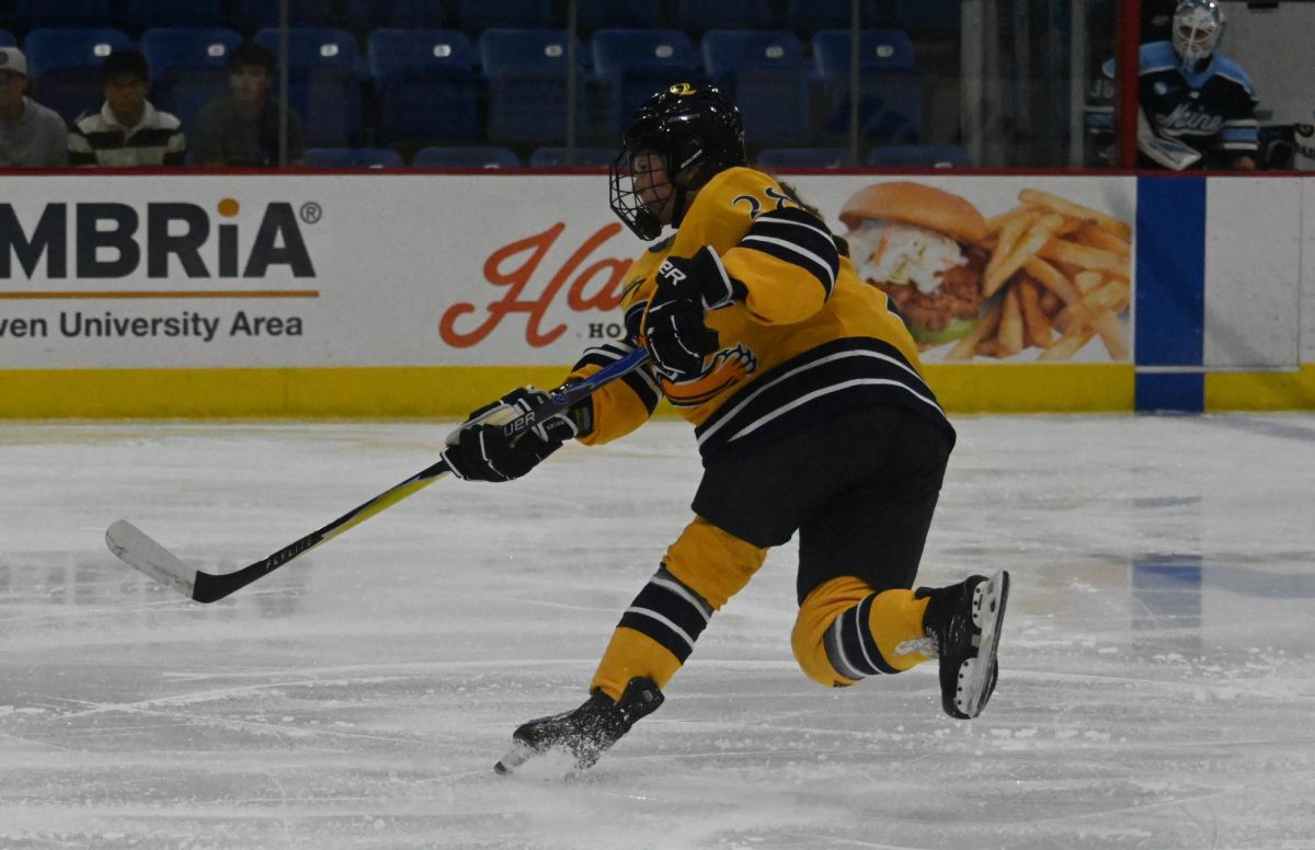Sophomore defenseman Makayla Watson shoots against Maine on Sept. 26.