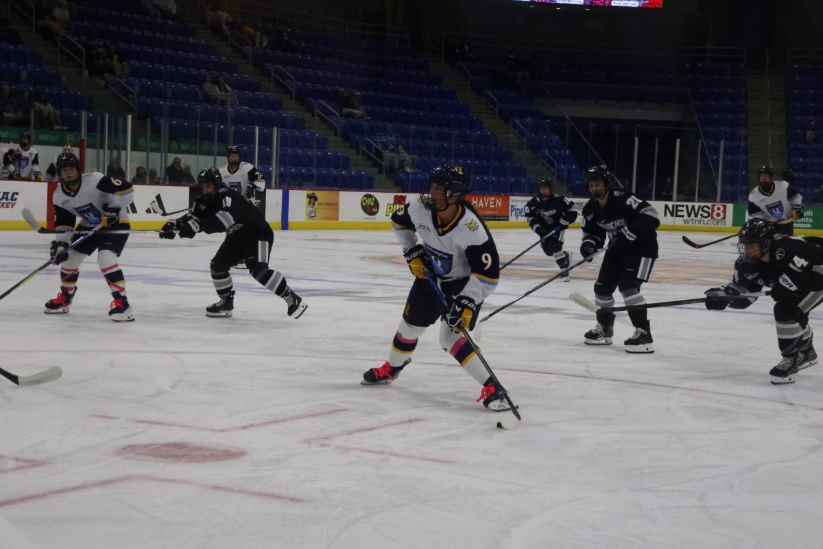 Sophomore forward Taylor Brueske skates with the puck in the Friars zone on Oct. 4.