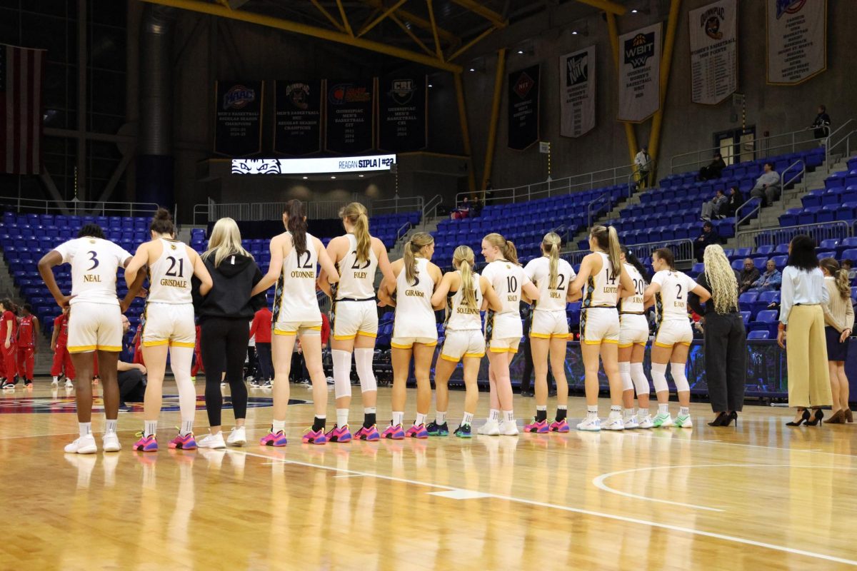 Quinnipiac women's basketball groups together before the national anthem.
