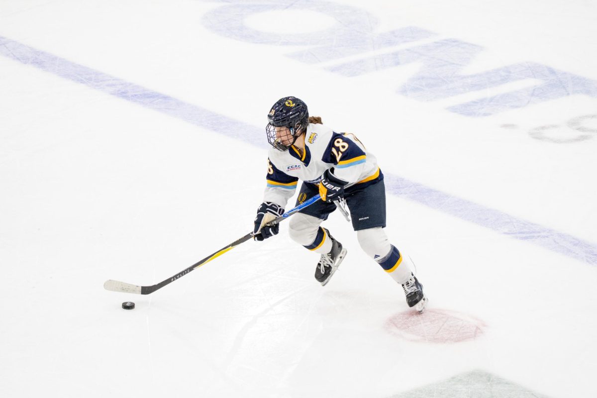 Sophomore defenseman Makayla Waston stick handles down ice against Northeastern on Oct. 18.