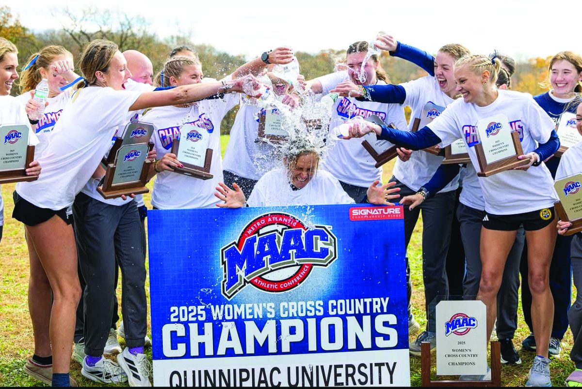 Women’s cross country showers head coach Carolyn Martin after winning fourth consecutive MAAC Title on Nov. 1. (Rob Rasmussen/QU Athletics)